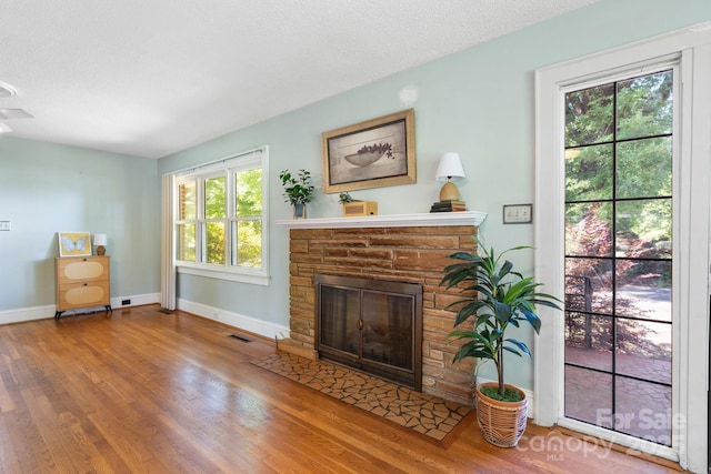 3418 Sulphur Springs Rd NE, Hickory, NC 28601 - living room featuring a fireplace, wood finished floors, and baseboards