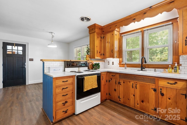 3418 Sulphur Springs Rd NE, Hickory, NC 28601 - kitchen with electric stove, a sink, decorative backsplash, and a peninsula