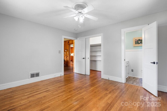 3418 Sulphur Springs Rd NE, Hickory, NC 28601 - unfurnished bedroom featuring light wood finished floors, baseboards, a closet, a spacious closet, and ceiling fan