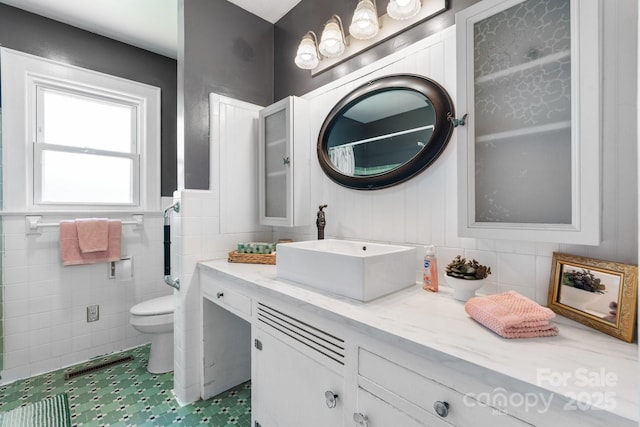 3418 Sulphur Springs Rd NE, Hickory, NC 28601 - full bathroom featuring toilet, tile walls, vanity, and a wainscoted wall