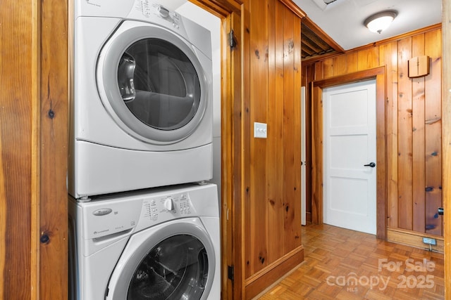 3418 Sulphur Springs Rd NE, Hickory, NC 28601 - clothes washing area featuring stacked washer and clothes dryer and wood walls