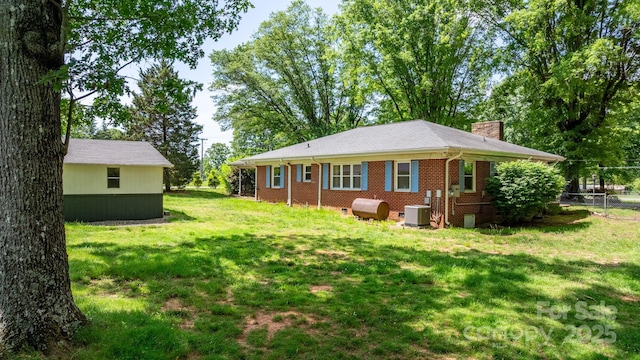 3418 Sulphur Springs Rd NE, Hickory, NC 28601 - back of house featuring a chimney, central AC, brick siding, and oil tank