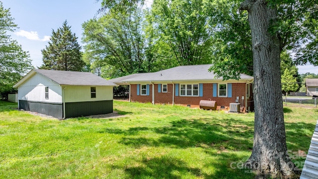 3418 Sulphur Springs Rd NE, Hickory, NC 28601 - rear view of property with a yard, central AC unit, an outdoor structure, and brick siding