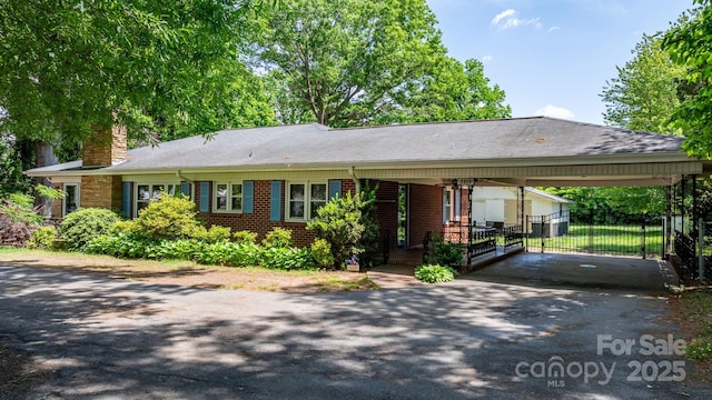 3418 Sulphur Springs Rd NE, Hickory, NC 28601 - ranch-style home featuring brick siding, asphalt driveway, fence, and a chimney