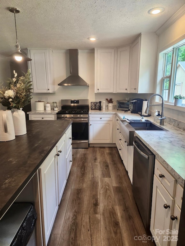 2025 Kisatchie Dr, Hickory Grove, SC 29717 - kitchen with wall chimney range hood, appliances with stainless steel finishes, dark wood-type flooring, a textured ceiling, and white cabinetry