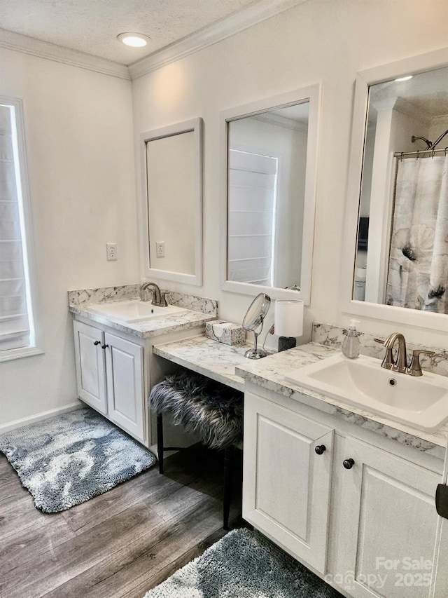 2025 Kisatchie Dr, Hickory Grove, SC 29717 - bathroom with two vanities, wood finished floors, and crown molding