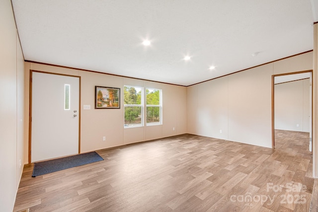 unfurnished living room featuring crown molding, light wood-style flooring, and recessed lighting