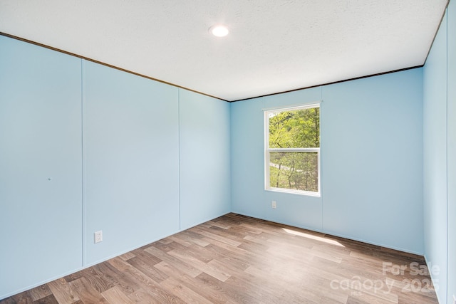 spare room with wood finished floors