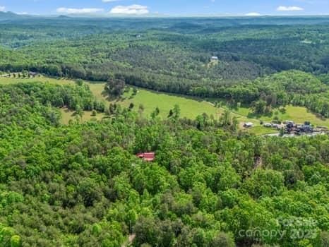 birds eye view of property featuring a wooded view