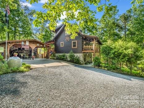 view of side of home featuring gravel driveway