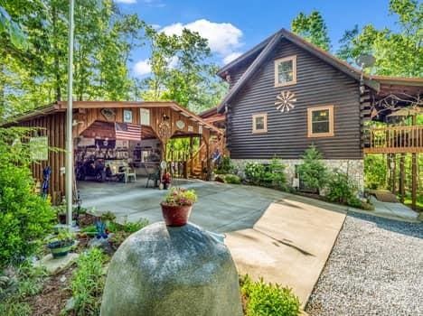back of house featuring a patio and log exterior