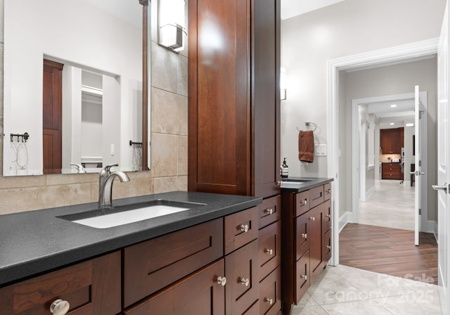 435 S Tryon St Unit 601, Charlotte, NC 28202 - bathroom with wood finished floors, vanity, and backsplash