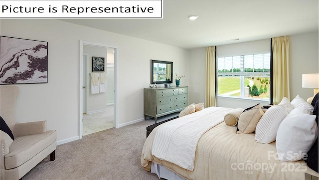 carpeted bedroom featuring baseboards and ensuite bathroom