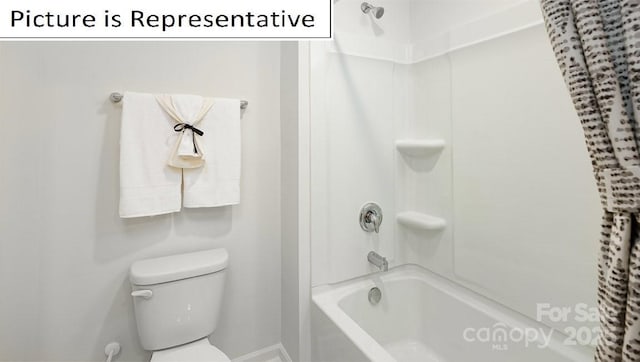 bathroom featuring baseboards, shower / tub combination, and toilet
