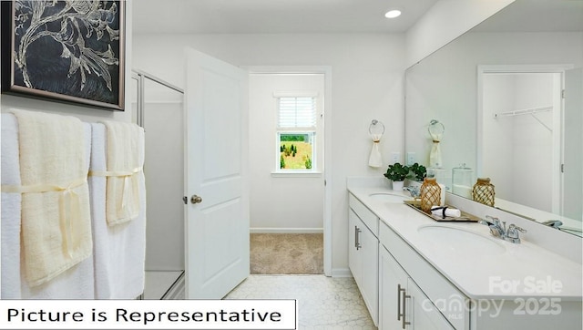 full bath with double vanity, baseboards, recessed lighting, and a sink