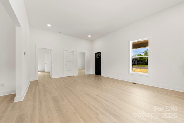 empty room with recessed lighting, baseboards, visible vents, and light wood-style flooring