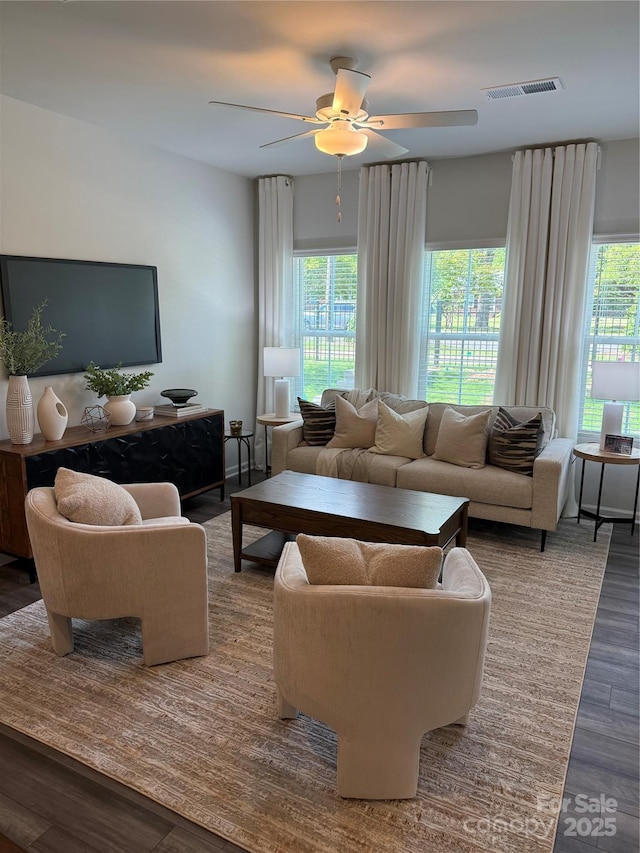living room featuring visible vents, ceiling fan, wood finished floors, and a healthy amount of sunlight