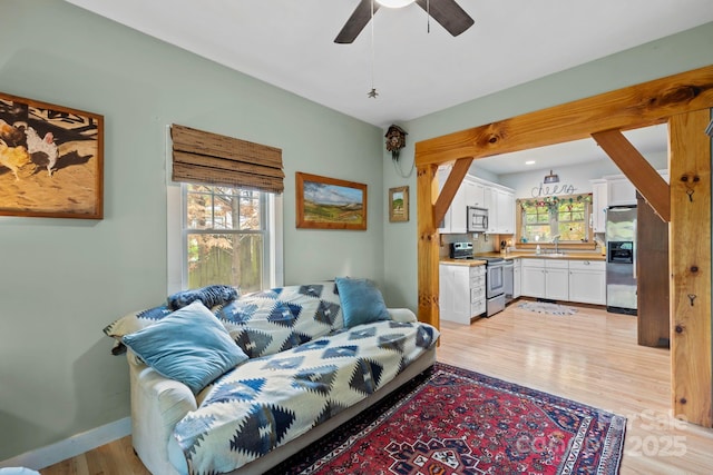 102 Altamahaw Ave, Black Mountain, NC 28711 - living room with light wood-style floors, a ceiling fan, and baseboards