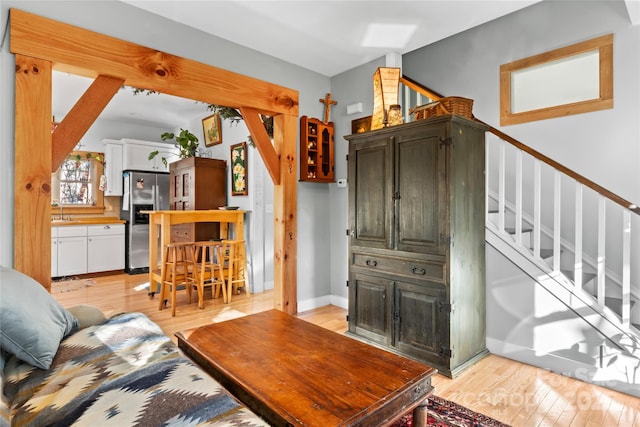 102 Altamahaw Ave, Black Mountain, NC 28711 - living room with light wood finished floors, stairway, and baseboards