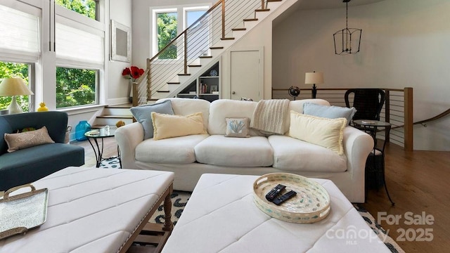 living room with stairway and wood finished floors
