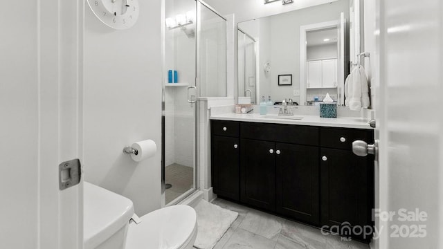 bathroom with vanity, a stall shower, toilet, and marble finish floor
