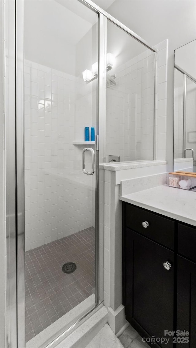 bathroom featuring vanity and a stall shower