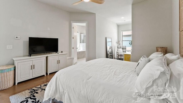 bedroom with ceiling fan, wood finished floors, and ensuite bathroom