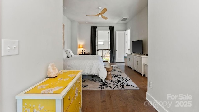 bedroom featuring a ceiling fan, dark wood finished floors, and visible vents