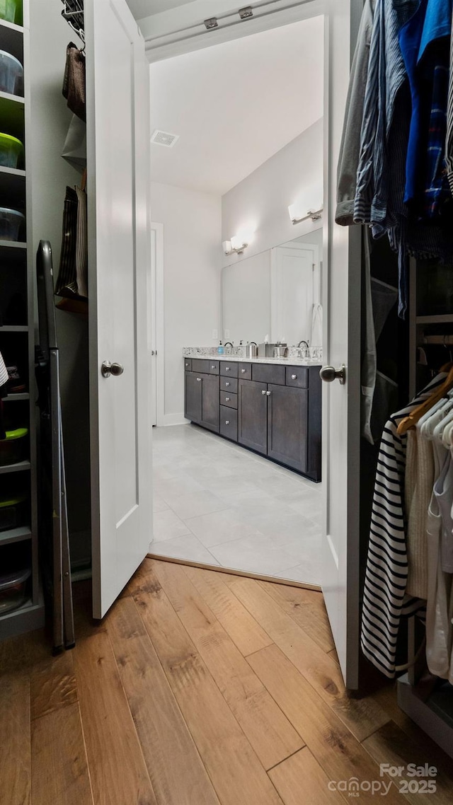 bathroom featuring visible vents, hardwood / wood-style flooring, and vanity