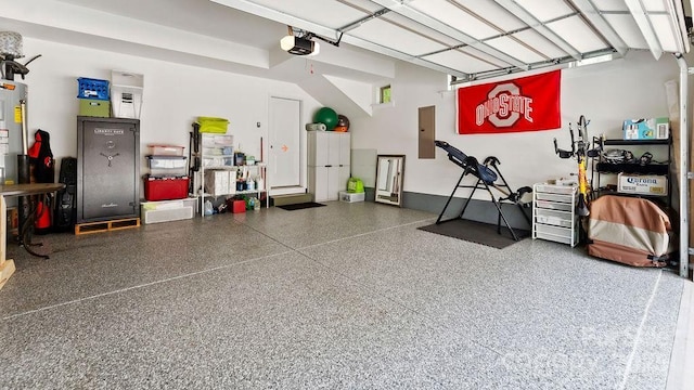 garage with a garage door opener and electric panel