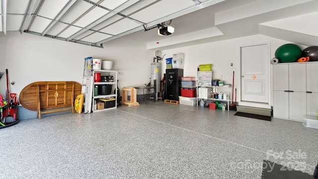 garage with water heater and a garage door opener
