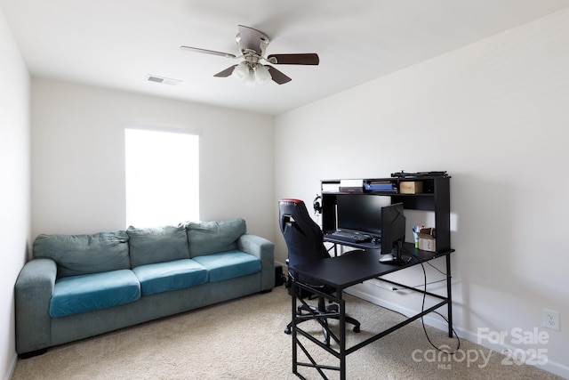 carpeted home office featuring visible vents and ceiling fan