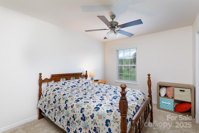 carpeted bedroom with baseboards and a ceiling fan