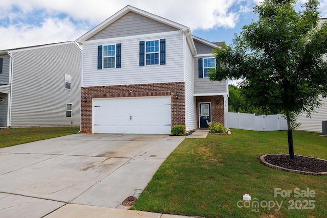 traditional-style home featuring fence, brick siding, driveway, a garage, and a front lawn