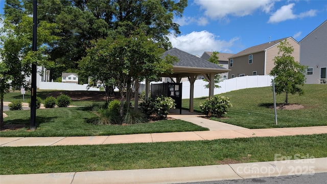 surrounding community featuring a lawn and fence