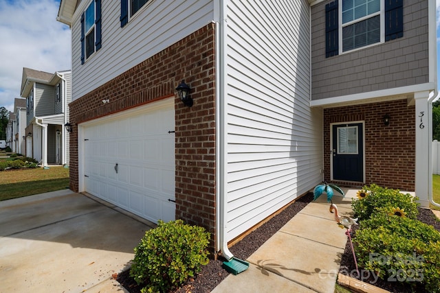 316 Gaines Rd, Clover, SC 29710 - doorway to property with brick siding, a garage, and concrete driveway