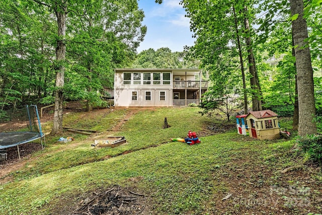 3690 Birchwood Ln, Denver, NC 28037 - rear view of property with a trampoline and a lawn