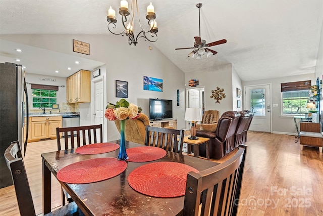 3690 Birchwood Ln, Denver, NC 28037 - dining room featuring light wood-type flooring, a ceiling fan, a chandelier, baseboards, and high vaulted ceiling