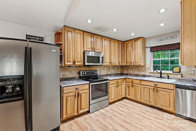 3690 Birchwood Ln, Denver, NC 28037 - kitchen featuring stainless steel appliances, a sink, light wood-type flooring, tasteful backsplash, and recessed lighting