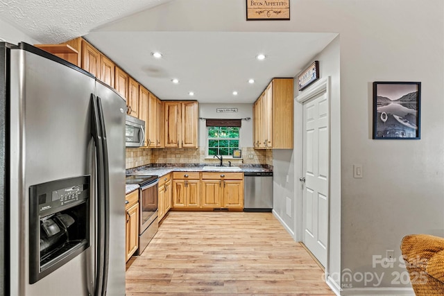 3690 Birchwood Ln, Denver, NC 28037 - kitchen featuring appliances with stainless steel finishes, light wood-style floors, recessed lighting, a sink, and backsplash