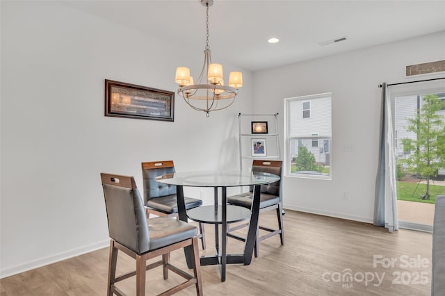 12110 Chesapeake Mallard Dr, Charlotte, NC 28262 - dining area featuring light wood-type flooring, a chandelier, healthy amount of natural light, baseboards, and recessed lighting