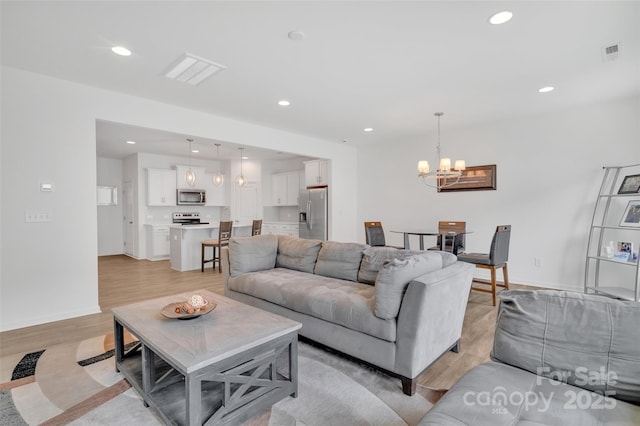 12110 Chesapeake Mallard Dr, Charlotte, NC 28262 - living area with light wood-style floors, a chandelier, recessed lighting, and baseboards