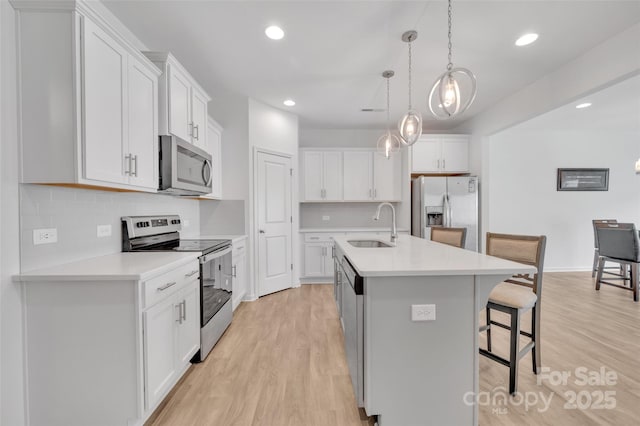 12110 Chesapeake Mallard Dr, Charlotte, NC 28262 - kitchen with appliances with stainless steel finishes, a sink, a kitchen breakfast bar, tasteful backsplash, and an island with sink