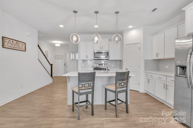 12110 Chesapeake Mallard Dr, Charlotte, NC 28262 - kitchen featuring appliances with stainless steel finishes, recessed lighting, a breakfast bar, light countertops, and backsplash