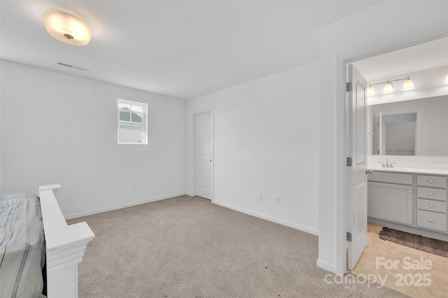12110 Chesapeake Mallard Dr, Charlotte, NC 28262 - unfurnished bedroom with light colored carpet, a sink, baseboards, and connected bathroom