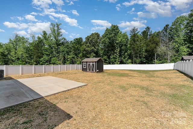 view of yard with an outdoor structure, cooling unit, a fenced backyard, a patio area, and a storage shed