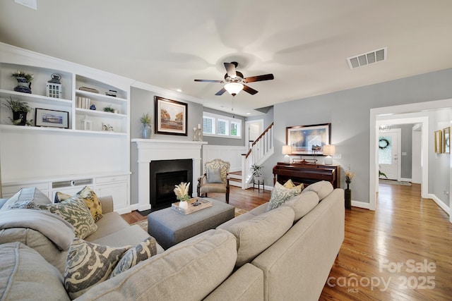 3426 Richards Xing, Fort Mill, SC 29708 - living room with stairway, ceiling fan, wood finished floors, a fireplace, and baseboards