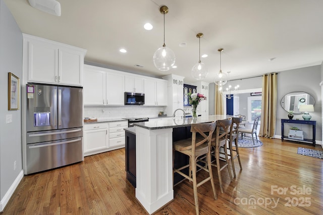3426 Richards Xing, Fort Mill, SC 29708 - kitchen with appliances with stainless steel finishes, dark stone counters, tasteful backsplash, white cabinets, and recessed lighting