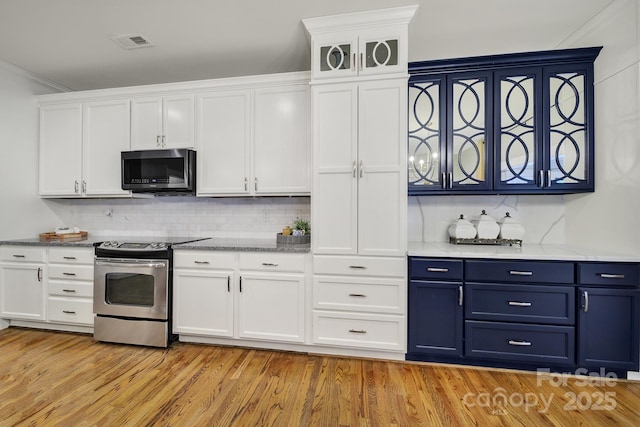 3426 Richards Xing, Fort Mill, SC 29708 - kitchen with stainless steel range with electric cooktop, blue cabinetry, white cabinets, and tasteful backsplash