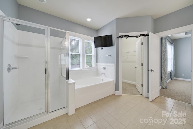 3426 Richards Xing, Fort Mill, SC 29708 - bathroom featuring a shower stall, a bath, a walk in closet, baseboards, and tile patterned flooring
